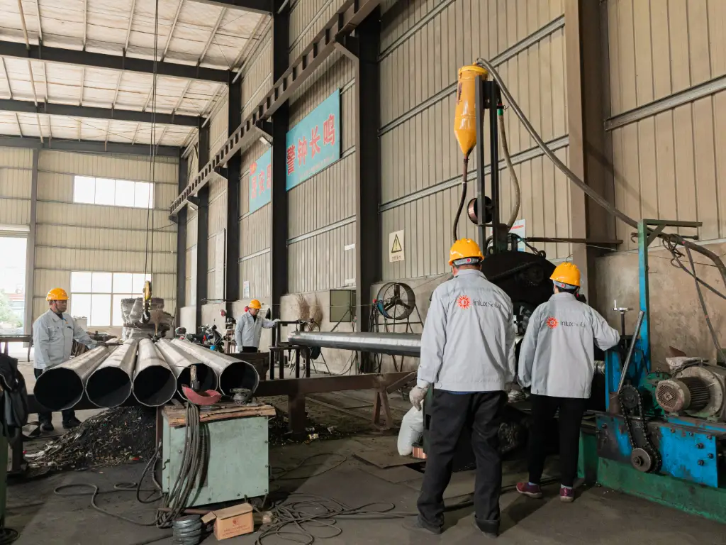 Light pole production workshop, many workers working on the production line